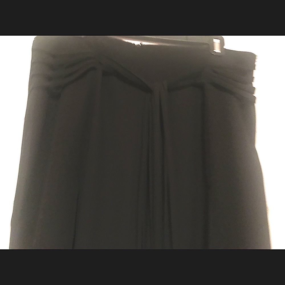 Black pants compliments waist flairs through hips